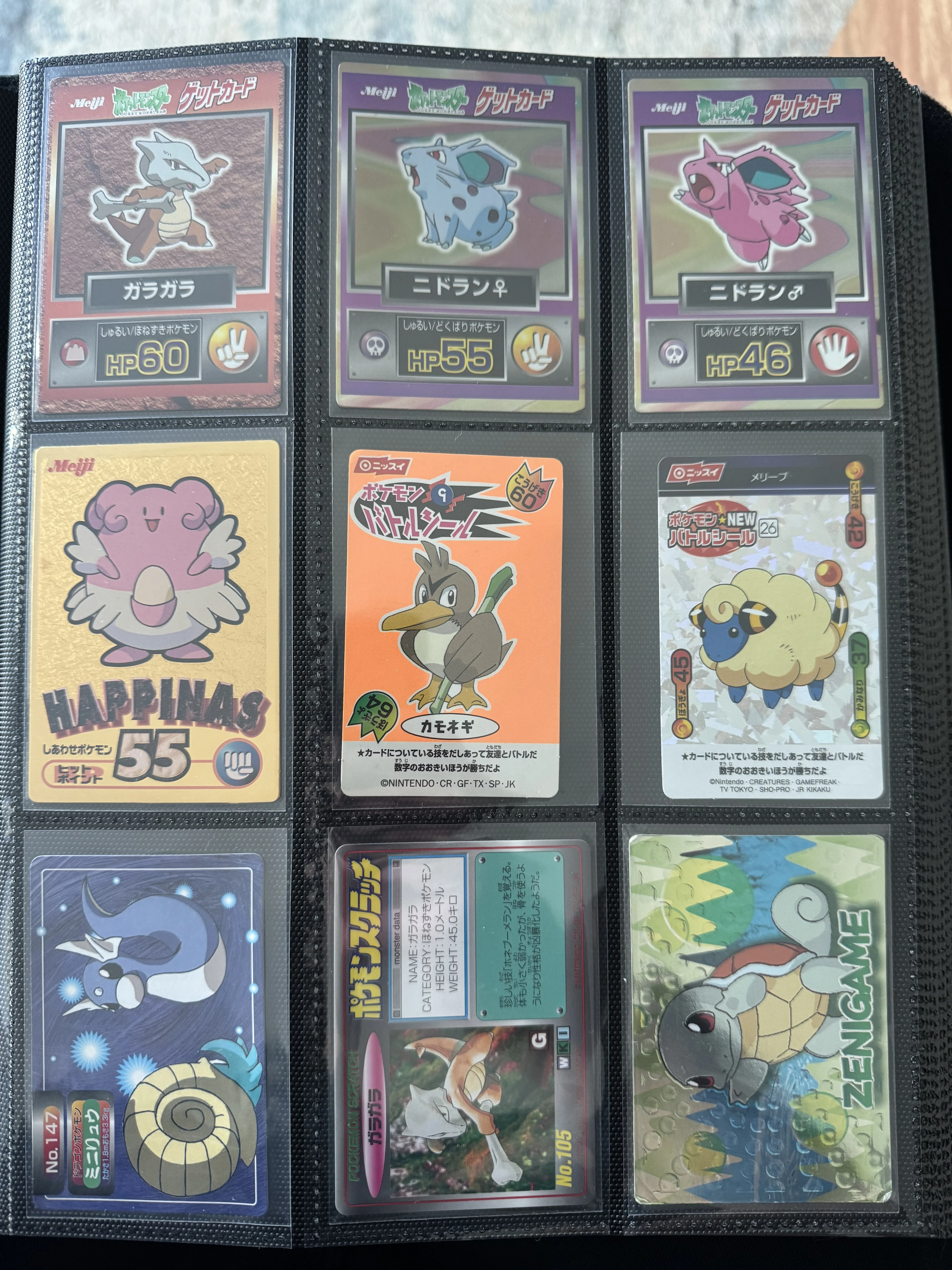 Binder page with Meiji cards, Tomy Scratch cards, and other pre-TCG Pokémon cards