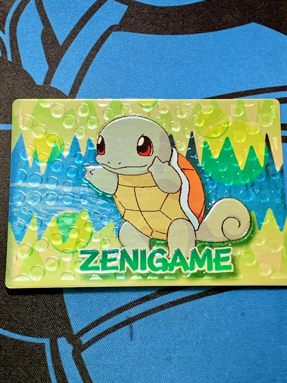 1999 Meiji embossed Squirtle card showing Zenigame written in Romaji