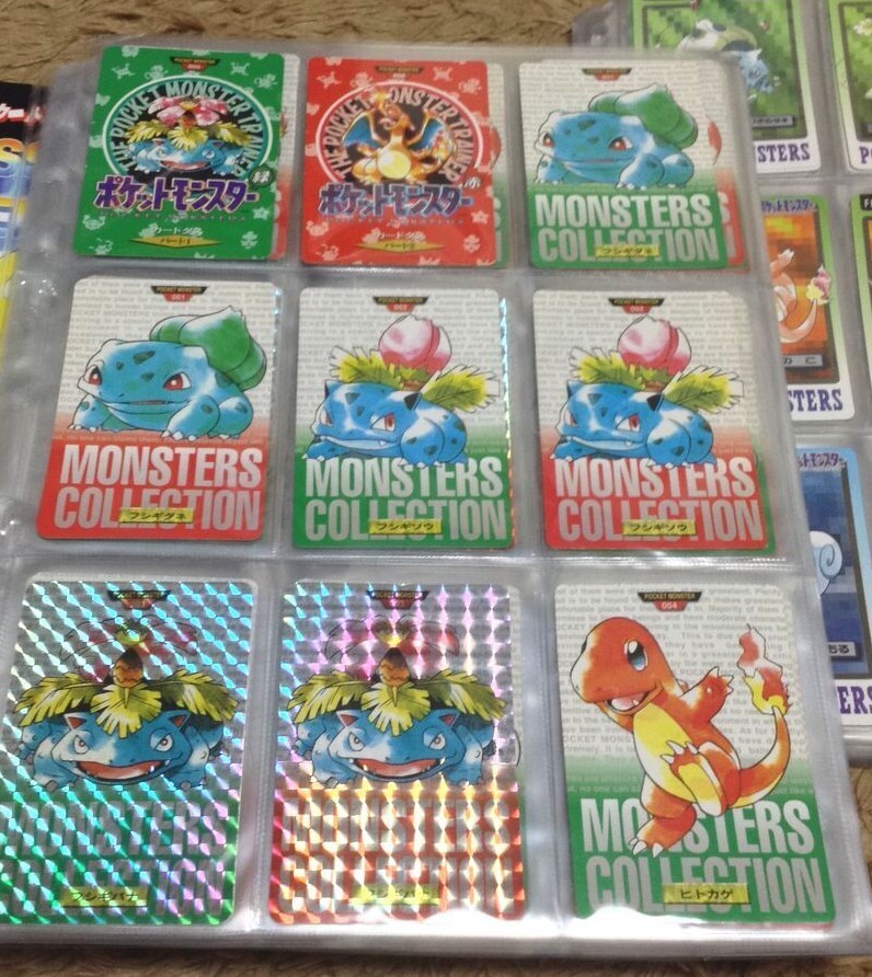 Binder page of early Carddass cards showing standard Monsters Collection cards and prism holos